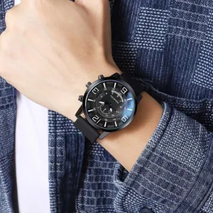 Men's quartz watch with large dial and black silicone strap on a blue suit background
