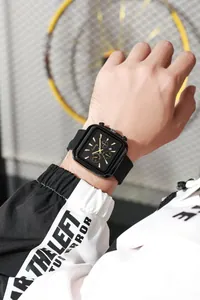 Detailed macro view of the rectangular black quartz watch with silicone strap and date window