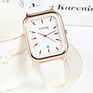 Montre à quartz carrée avec boîtier en or rose, bracelet en silicone blanc et dateur