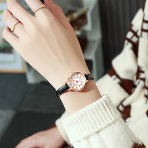 Elegant women's quartz watch with black leather strap and rose gold round case on wrist