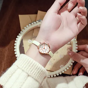 Detailed view of elegant quartz watch with rose gold dial and slim yellow leather strap