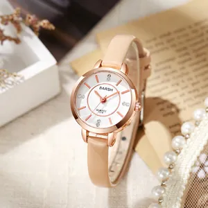 Detail of rose gold quartz watch with beige leather strap and textured white dial