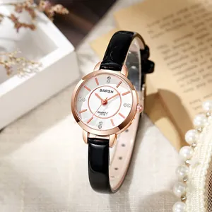 Close-up of rose gold quartz watch with white dial, diamond markers and black leather strap