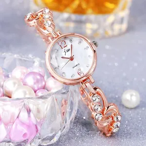 Elegant rose gold women's watch with crystal chain strap and white rhinestone dial