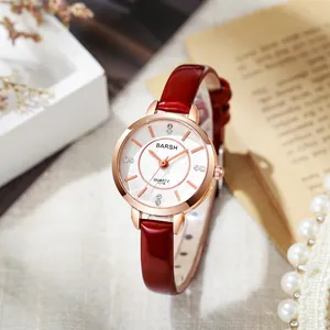 Detail of round rose gold quartz watch with red leather strap and pearl jewelry