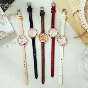 Flat lay of multiple leather strap quartz watches with rose gold cases and rhinestone markers