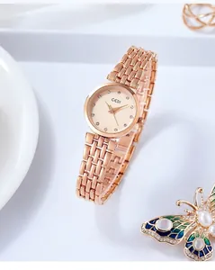 Detail of rose gold quartz watch with crystal indices and elegant metal link bracelet