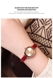 Detail of rose gold square quartz watch with red leather strap on woman's wrist