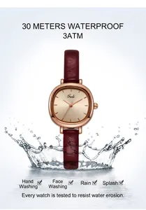 Rose gold quartz watch with red leather strap shown splashing in water for 3ATM waterproof test
