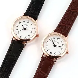 Close-up of leather strap texture and calendar display on dual quartz watches
