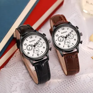 Close-up of black and brown leather strap quartz watches with multi-dial display