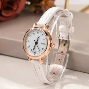 Detail of elegant white leather strap and rose gold quartz watch on a display stand