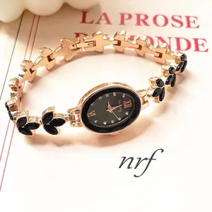 Elegant rose gold oval watch for women with black floral strap and rhinestone dial