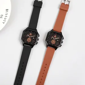 Macro shot of two square quartz watches with silicone bands and rose gold details