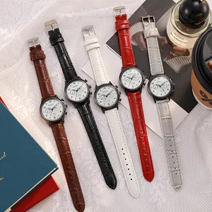 Flat lay of multiple leather strap watches with embossed patterns and round dials