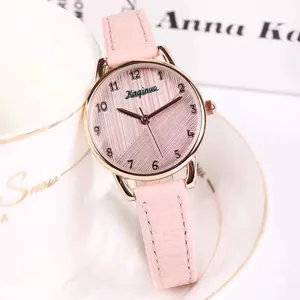 Close-up of pink leather strap and rose gold quartz watch dial for women