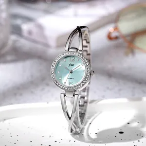 Detail of silver ladies watch with light blue dial and sparkling rhinestone bezel