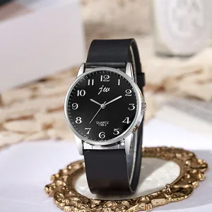 Close-up of minimalist quartz watch with black dial and silver case on elegant gold stand
