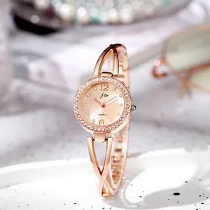 Detail of rose gold quartz watch featuring a diamond-set bezel and elegant crisscross band