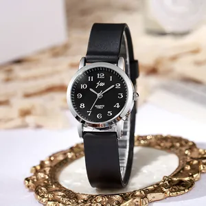 Detailed close-up of a stylish quartz watch with black dial and silver bezel on a gold base