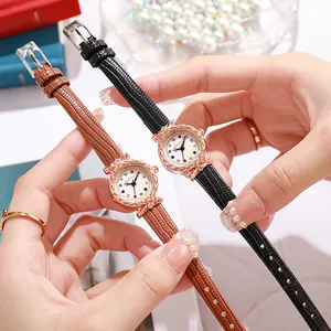 Detail of round quartz watches with slim leather straps in black and brown finishes