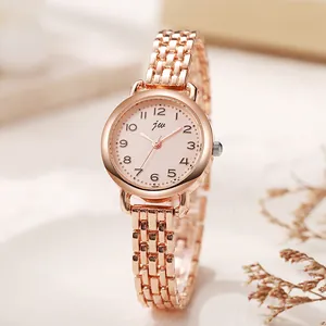 Gros plan du bracelet en or rose et cadran rose avec chiffres arabes noirs
