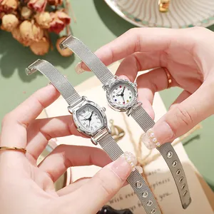 Fashionable women's silver mesh watch set with oval and round dials and crystal markers