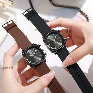 Close-up of stylish square men's watches with black and brown silicone bands