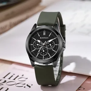 Detailed close-up of a BARSH sports watch with a black dial and green silicone strap
