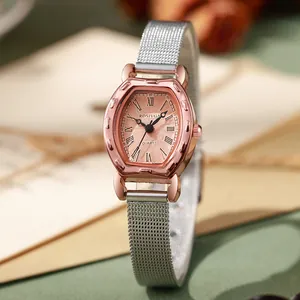 Detail of rose gold horseshoe watch case with silver mesh band and retro dial texture