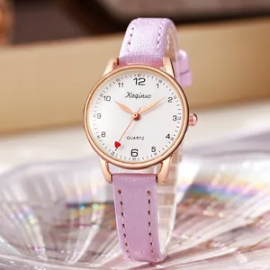 Macro view of white dial quartz watch with red heart second hand and lavender glitter strap