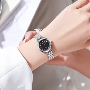 Close-up of elegant silver link strap watch with black rhinestone dial on wrist
