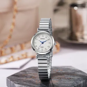 Detailed macro view of BARSH silver quartz watch dial with blue hands and steel strap
