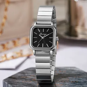 Detailed macro view of square black dial and brushed silver metal strap of fashion watch