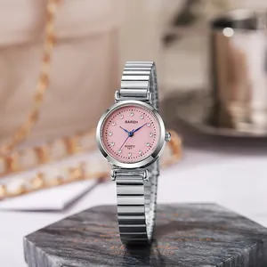 Detail of round silver watch with pink dial and sparkling rhinestone hour markers