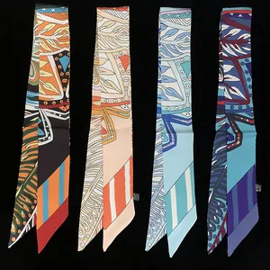 Macro detail of four assorted narrow twilly scarves with leaf and geometric patterns