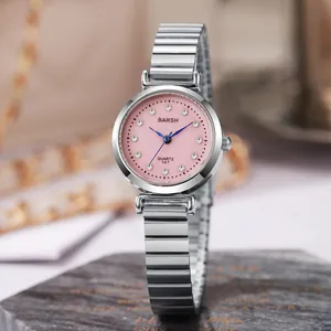 Detailed macro view of a pink sunray dial ladies watch with sparkling diamond hour markers