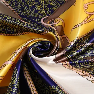 Macro view of luxurious satin scarf with golden chain and paisley vintage print