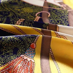 Detailed macro view of luxurious satin silk scarf with nautical rope and tassel patterns