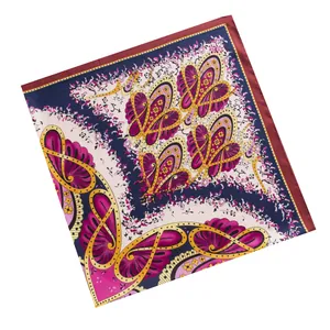 Detailed pattern of paisley and butterfly motifs on a navy silk twill square scarf
