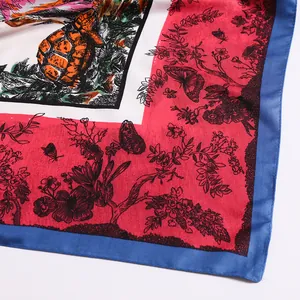 Detail of silk-texture scarf featuring colorful sea turtle, flowers, and butterfly prints
