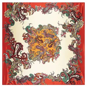 Close-up of colorful paisley silk-like square scarf with red border and satin texture