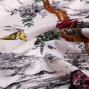 Macro view of twill silk scarf showing forest animals and vibrant digital floral patterns