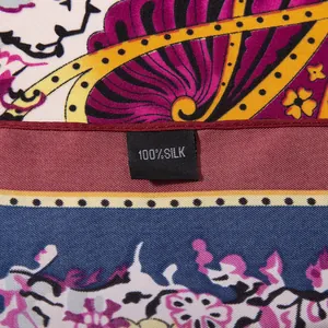 Detail of 100% silk twill scarf showing cashew floral pattern and material label