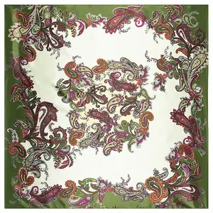 Close-up detail of green paisley silk scarf texture with floral patterns on silk fabric