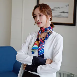 Detail view of long blue silk scarf with geometric stripe patterns on a model's neck