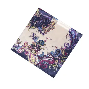 Detailed view of square paisley silk-like scarf with vibrant navy and cream floral pattern