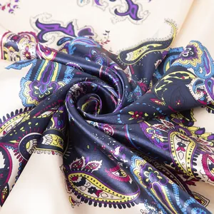 Macro detail of paisley pattern on folded silk scarf with rich colors and soft texture
