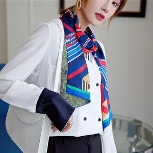 Detail of geometric stripe printed silk scarf styled with a professional white blouse