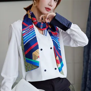 Detailed view of geometric striped silk scarf styled with a navy blazer for office wear